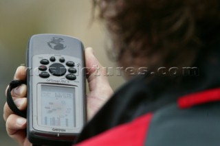 Man using Garmin handheld GPS navigation equipment