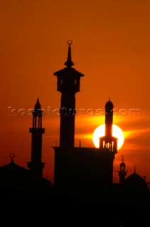 Silhouette of mosque towers at sunset, Dubai - United Arab Emirates.