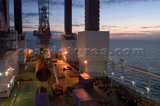 Construction of Windfarm on the Kentish flats in the Thames estuary off Whitstble Kent. Onboard the construction ship Resolution durint the foundation process, where the Monopile is hammered in to the seabed with a hydraulic hammer and the transition piece lowered onto the monopile, .