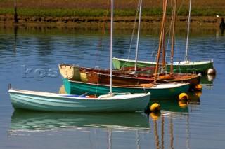 Wooden dinghies moored on river