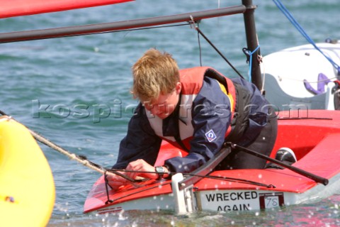 Young sailor untying line on his Topper dinghy 