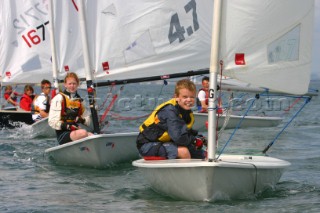 Young kids racing Laser dinghies