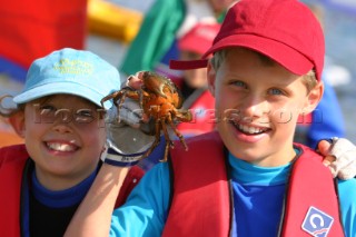 Two boys holding a crab