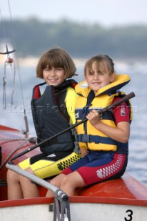 Two young girls sailing dinghy