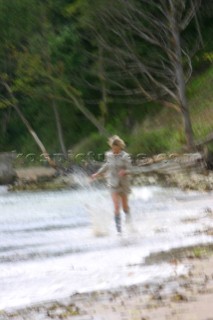 Girl running through water.