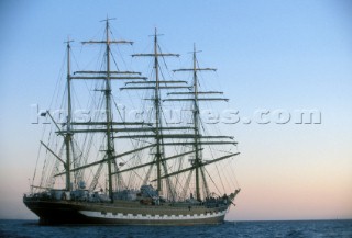 Tall ship Kruzenstern with sails furled at sunset