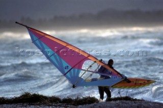 Windsurfer leaves the water with his rig