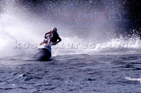Jet Skier racing across flat water