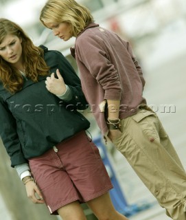 Two girls standing on dockside.