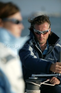 Crew member wearing Henri Lloyd jacket grinding winch