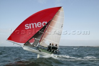 Three crew flying down wind on an 18 ft Skiff