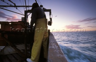 Fishermen in Solent at dawn, UK
