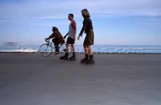 Rollerbladers and cyclist on Promenade des Anglais, Nice, France