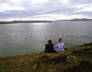 Two people enjoying the view from St Davids Head, Pembrokeshire, Wales
