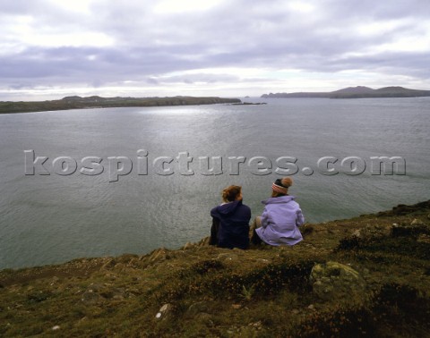 Two people enjoying the view from St Davids Head Pembrokeshire Wales