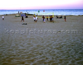 Beach volleyball game after sunset, Sandbanks, Dorset