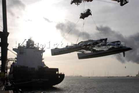 Crane lifting G Class catamaran Cayenne on to a container ship in the Port of Antwerp Belgium