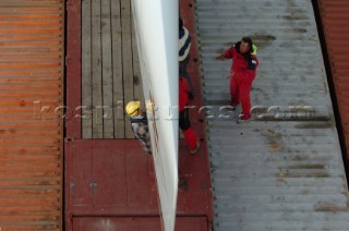Crew securing bow of G Class catamaran Cayenne on to a container ship in the Port of Antwerp, Belgium