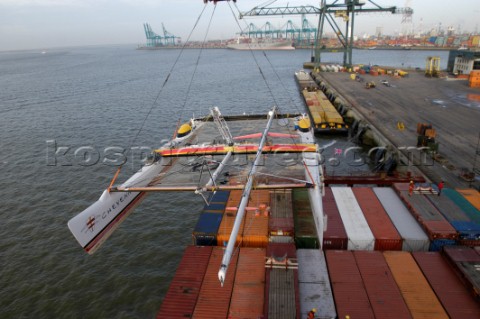 Crane lifting G Class catamaran Cayenne on to a container ship in the Port of Antwerp Belgium