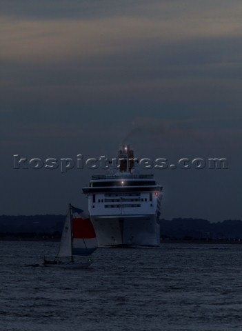 PO cruise ship Aurora with navigation lights at night turning sharply to avoid collision with a smal