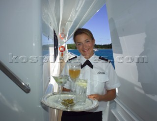 Superyacht stewardess with tray of drinks