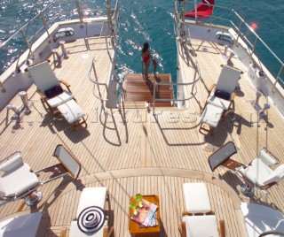 Sun loungers and chairs on aft deck of superyacht