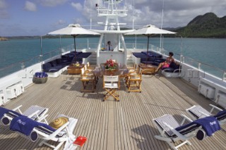 Sun loungers and chairs on aft deck of superyacht