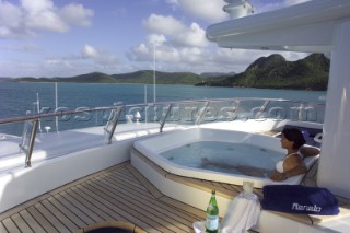Woman in jacuzzi on deck of superyacht