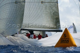 Crew of Swan yacht dropping spinnaker at race mark