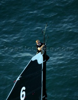 Sailor inspecting mast head on Open 60