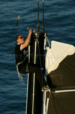 Sailor inspecting mast head on Open 60