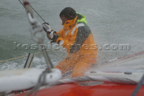 Skipper of the Open 60 Ocean yacht Alex Thomson gets  soaked in rough seas