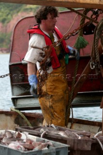 Fisherman working chains on trawler