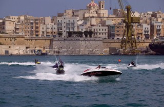 Jet skis and water bikes chasing a Seadoo speedboat