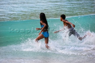Tortola Island - British Virgin Islands - . Cane Garden Bay -. Local Children playing with the waves