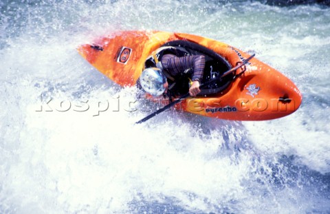 Canoeist makes sharp turn over rapids on the Zambezi River Zambia