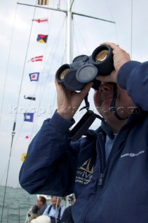 Man looking through binoculars on board Gipsy Moth