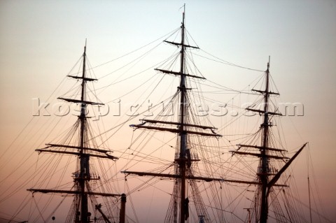 Silhouette of square rigger masts at sunset