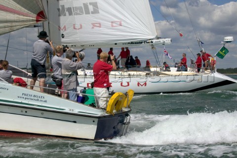 Photographers shooting Simon Le Bon of Duran Duran as he sails his maxi yacht Arnold Clark Drum acro