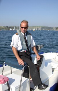 Salcombe Harbour Master official controlling speeding boats using a police radar gun