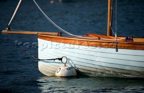 Artistic bow shot of a Salcombe Yawl moored to a bouy in the evening light