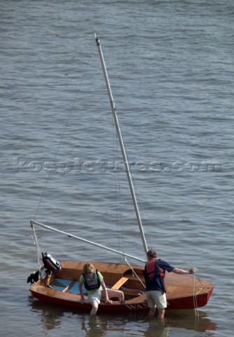 Couple landing ashore from a dinghy