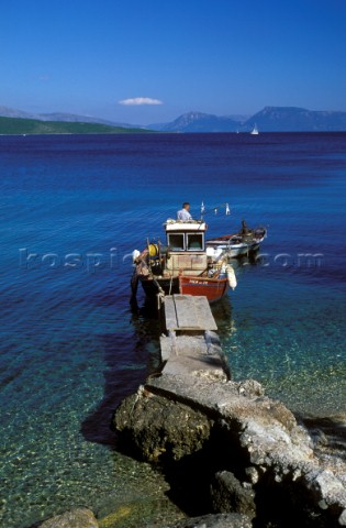 Fishing boat moored at end of jetty Lighia Lefkas Ionian Islands