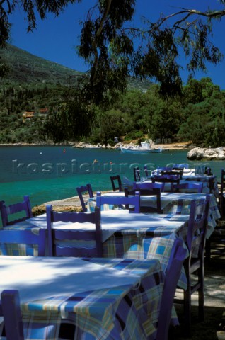 Tables and chairs at restaurant on the beach Vathy Ithaca Ionian Islands