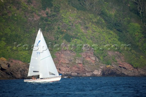 Cruising yacht sailing off the Devon coast UK