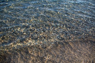 Clear water on shingle beach