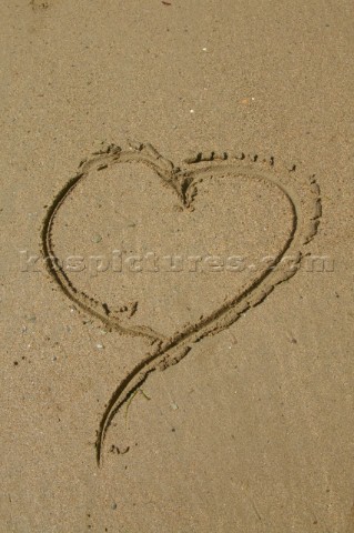 Heart drawn on wet sand