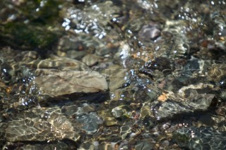 Texture of shallow water over rocks and pebbles