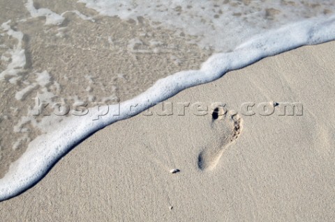 Footprint on wet sand
