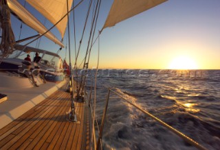 Sailing a cruising yacht in the sunset